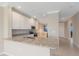 Modern kitchen featuring white cabinetry, granite countertops, and stainless steel appliances at 12410 Osorio Ct # 101, Sarasota, FL 34238