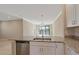 Bright kitchen featuring granite countertops, stainless steel dishwasher, and a view to the outdoor lanai at 12410 Osorio Ct # 101, Sarasota, FL 34238