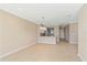 Open-concept living area with tile floors flowing into a kitchen with a breakfast bar at 12410 Osorio Ct # 101, Sarasota, FL 34238