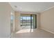 Bright, airy living room with tile floors, large sliding doors, and views of the water at 12410 Osorio Ct # 101, Sarasota, FL 34238