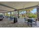 Inviting outdoor dining area with brick pavers, ceiling fans, and views of the pool and landscape at 12410 Osorio Ct # 101, Sarasota, FL 34238