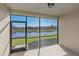 Screened patio overlooking a serene pond and well-manicured lawns at 12410 Osorio Ct # 101, Sarasota, FL 34238