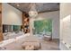 An elegant spa room with wood-look floors, custom shelving, and a serene garden view at 12410 Osorio Ct # 101, Sarasota, FL 34238