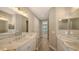 Modern bathroom with double vanity and access to bedroom at 12681 Palatka Dr, Venice, FL 34293