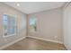Well-lit bedroom featuring wood-look floors and dual windows at 12681 Palatka Dr, Venice, FL 34293