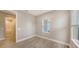 Bright bedroom with wood-look tile floors, double closet, and window at 12681 Palatka Dr, Venice, FL 34293