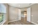 Bedroom with wood-look tile flooring and access to a nearby kitchen at 12681 Palatka Dr, Venice, FL 34293