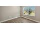 Well-lit bedroom with wood-look tile flooring and a window with blinds at 12681 Palatka Dr, Venice, FL 34293
