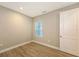 Simple bedroom with wood-look floors and a window at 12681 Palatka Dr, Venice, FL 34293