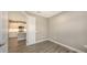 Spacious bedroom with wood-look tile flooring and kitchen views at 12681 Palatka Dr, Venice, FL 34293