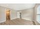 Bedroom with wood-look floors, neutral walls, and ensuite bathroom at 12681 Palatka Dr, Venice, FL 34293