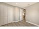 Bedroom with wood-look floors, closet, and kitchen view at 12681 Palatka Dr, Venice, FL 34293