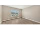 Bright bedroom with wood-look floors and a large window at 12681 Palatka Dr, Venice, FL 34293