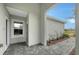 Covered entryway with tile flooring and landscaping at 12681 Palatka Dr, Venice, FL 34293