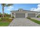 Two-car garage and paver driveway, landscape at 12681 Palatka Dr, Venice, FL 34293