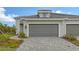 House exterior with gray garage door and walkway at 12681 Palatka Dr, Venice, FL 34293