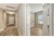 Bright hallway with wood-look tile flooring, leading to other rooms at 12681 Palatka Dr, Venice, FL 34293