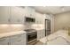 Modern kitchen with white cabinets and gold fixtures at 12681 Palatka Dr, Venice, FL 34293