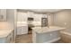 Modern kitchen with white cabinets and quartz island at 12681 Palatka Dr, Venice, FL 34293