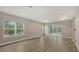 Spacious main bedroom with wood-look tile flooring and access to a private patio at 12681 Palatka Dr, Venice, FL 34293