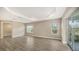 Spacious main bedroom with wood-look tile flooring and sliding glass doors to a patio at 12681 Palatka Dr, Venice, FL 34293