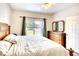 Spacious bedroom with a large window and wood furniture at 12732 Rockrose Gln, Lakewood Ranch, FL 34202