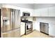 Modern kitchen with stainless steel appliances and white cabinets at 12732 Rockrose Gln, Lakewood Ranch, FL 34202