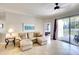 Tan sectional sofa and sliding glass doors leading to the patio at 12732 Rockrose Gln, Lakewood Ranch, FL 34202