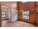 Bright dining area with wood walls and large windows offering natural light at 12845 N Branch Rd, Sarasota, FL 34240