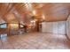 Vaulted living room with wood ceilings, tile floors, and a stone fireplace at 12845 N Branch Rd, Sarasota, FL 34240