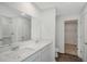 Main bathroom with double vanity, walk-in shower, and linen closet at 13009 Cedar Elm Lane, Parrish, FL 34219
