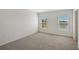 Spacious bedroom with neutral walls, carpeted floor, and two windows at 13009 Cedar Elm Lane, Parrish, FL 34219