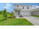 Two-story house, white siding, gray accents, and a two-car garage at 13009 Cedar Elm Lane, Parrish, FL 34219