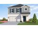 Two-story house with gray siding, white garage door, and landscaping at 13009 Cedar Elm Lane, Parrish, FL 34219