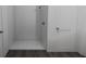 Simple bathroom with a shower, and dark wood-look flooring at 13017 Cedar Elm Lane, Parrish, FL 34219