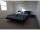 Bedroom with a navy bed, nightstand, and carpeted floor at 13017 Cedar Elm Lane, Parrish, FL 34219