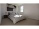 Bedroom with a striped comforter, nightstand and window at 13017 Cedar Elm Lane, Parrish, FL 34219