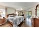 Main bedroom with wood floors, sliding doors to pool, and ensuite bathroom at 138 Mill E Run, Bradenton, FL 34212