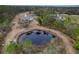 Aerial view of property with home, pond, and surrounding trees at 14150 Manatee Rd, Parrish, FL 34219