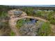 Aerial view of property with home, pond, and surrounding trees at 14150 Manatee Rd, Parrish, FL 34219