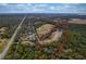 Aerial view of property showing home, detached shed and pond at 14150 Manatee Rd, Parrish, FL 34219