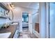 Elegant bathroom with double vanity, walk-in shower, and a view of the bedroom at 14150 Manatee Rd, Parrish, FL 34219