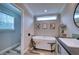 Relaxing bathroom with a freestanding soaking tub and a window bringing in natural light at 14150 Manatee Rd, Parrish, FL 34219