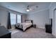 Spacious bedroom with a bed, nightstand, and large windows at 14150 Manatee Rd, Parrish, FL 34219