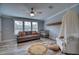 Bedroom with gray walls, crib, sofa and a ceiling fan at 14150 Manatee Rd, Parrish, FL 34219