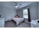 Cozy bedroom with a bed, nightstand, and a view of the backyard at 14150 Manatee Rd, Parrish, FL 34219