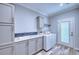 Convenient laundry room with washer, dryer, and extra storage at 14150 Manatee Rd, Parrish, FL 34219