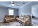 Relaxing living room with two reclining sofas and ceiling fan at 14150 Manatee Rd, Parrish, FL 34219
