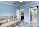 Light and airy living room featuring a comfortable recliner sofa and views into the kitchen at 14150 Manatee Rd, Parrish, FL 34219