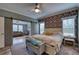 Spacious main bedroom with a king-size bed, sitting area, and barn door at 14150 Manatee Rd, Parrish, FL 34219